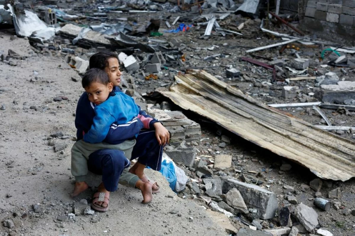 صوره – فتاة فلسطينية تعانق شقيقها لتهدئته بعد الغارة الإسرائيلية الإجرامية على خيمتهم في غزة.